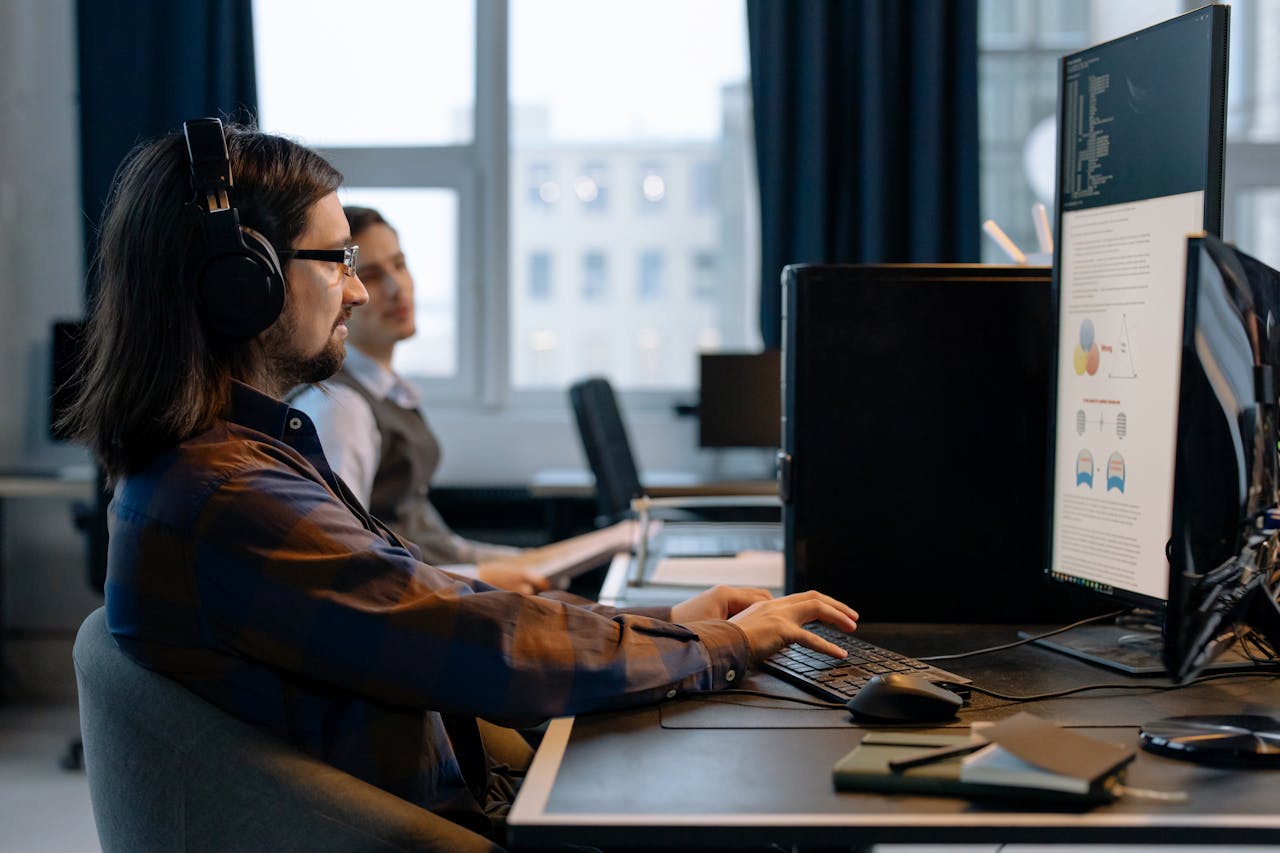 The Art of Drawing Readers In: Your attractive post title goes here Two programmers working together with focus on coding in a modern, tech-savvy office environment.
