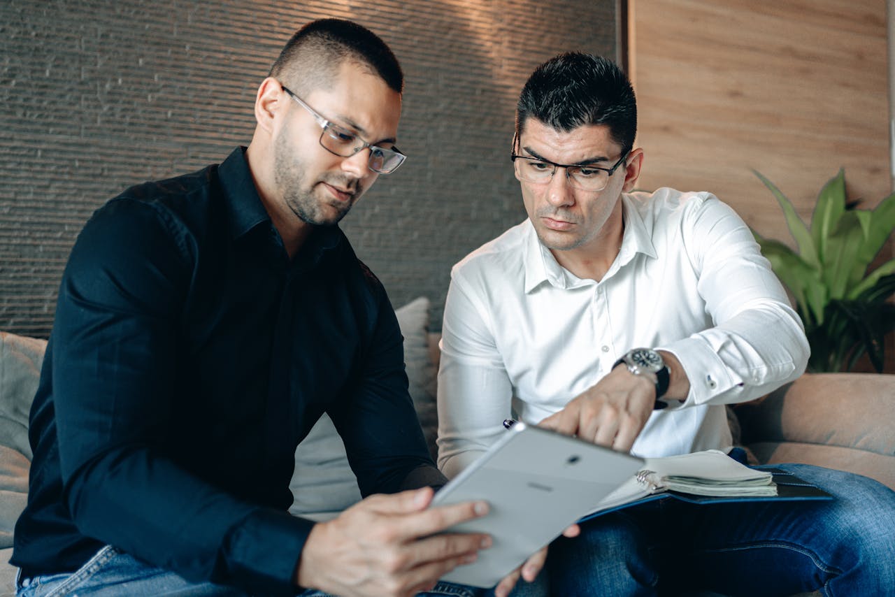 Mastering the First Impression: Your intriguing post title goes here Two men collaborating on a digital tablet indoors, focusing on teamwork.