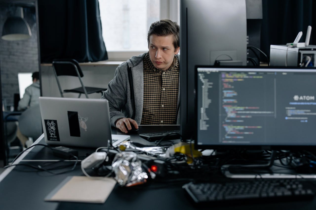 Crafting Captivating Headlines: Your awesome post title goes here A programmer in a modern office working on computer code, showcasing a focused work environment.